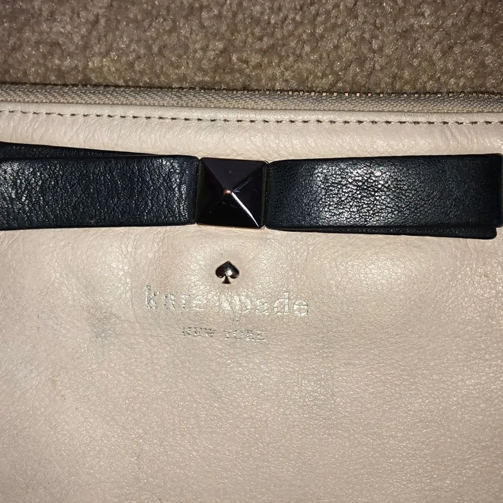 Kate Spade cream purse with a black bow